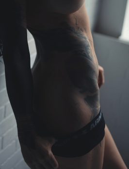 A photo of a woman's side glutes and hip bones